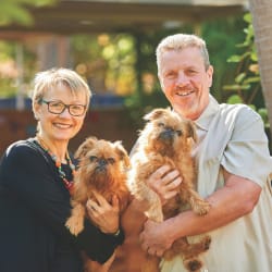 Smiling couple with their small dogs